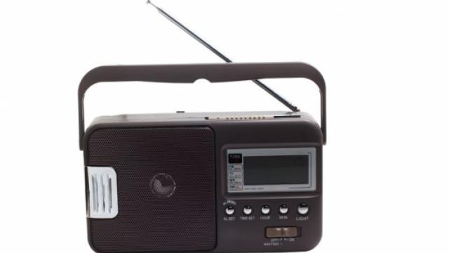 Image of black portable FM radio with silver button and a handle