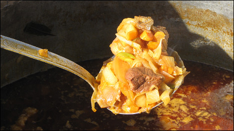 A spoonful of a meat cooked in sauce