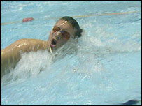 A man swimming in a pool.