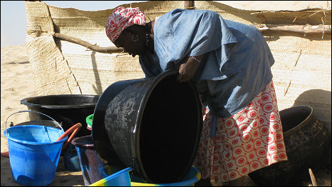 Madame Congo Coulibaly washing up