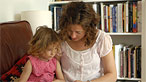 Woman reading to young girl