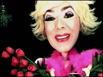 Clementine surrounded by red roses