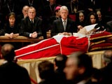 Body of John Paul II on display in Rome, with former American presidents George HW Bush and Bill Clinton in background