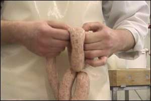 Butcher making sausages