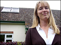 Woman standing outside her house