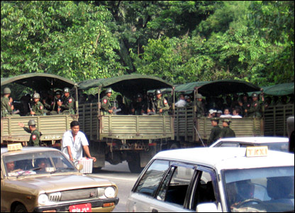 Army trucks in the street.