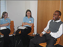 Comedian Jason Finn with two school pupils 