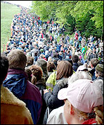 Spectators watch the cheese rolling