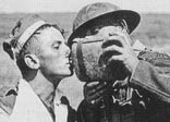 A British soldier giving a wounded German soldier a drink of water