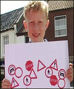Picture; Charlie looks at the highway code