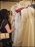 Inspecting the dresses up close before bidding begins