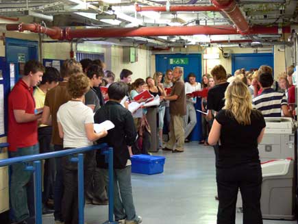 Crew and members of King's College Choir backstage at rehearsals
