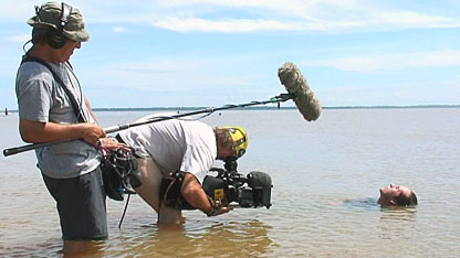 Bruce jumps into the water at the port of Belem, where the Amazon river meets the sea