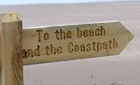 To the beach and the coastpath signpost