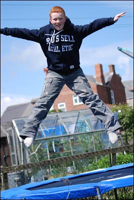 Boy jumping on trampoline