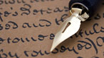 Photograph of a pen on a page of old writing