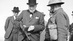 Churchill examines a Tommy gun during an inspection of invasion defences near Hartlepool, 31 July 1940.