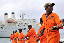 Workers haul part of a fibre optic cable onto the shore at the Kenyan port town of Mombasa