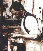 Worker grinding a decanter neck in the stoppering shop