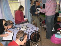 People recording a play in a bedroom