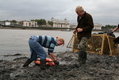 Dylan Winter and a volunteer cleaning the beach