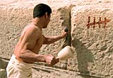 A reconstruction of a pyramid-worker chiselling stone in a quarry