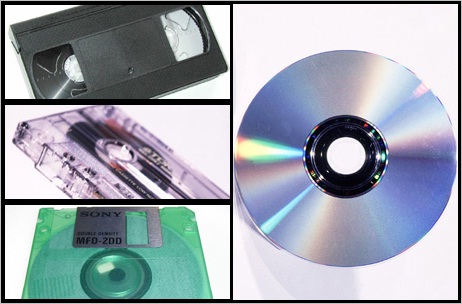 A video cassette (top left) audio cassette (centre left) and floppy disc (bottom left) and a CD (right)