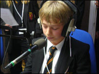 Pupil with headphones on in front of microphone