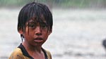 An achuar boy in the rain