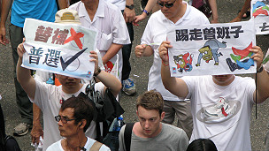 香港市民在參與七一遊行時高舉要求撤回立法會依稀遞補機制和曾蔭權下台的標語牌（1/7/2011）