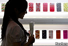 A young woman looking at mobile phones