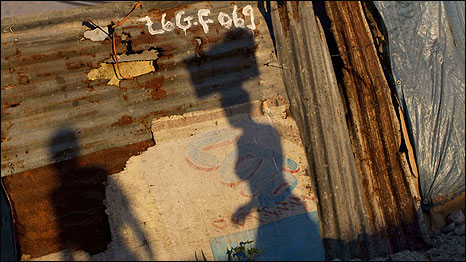 Shadows of people at a camp set up for earthquake victims in Haiti. Photo: AP Photo/Guillermo Arias
