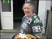 Woman carrying plate of nibbles