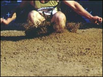 Jumping in the sand pit.