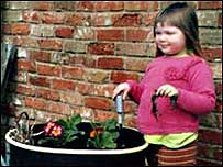 Sophie poses by her little garden.
