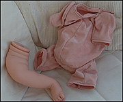 Parts of a reborning kit -  leg and unfilled body 