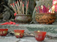 Many incense sticks standing in clay pots full of sand © iStockphoto/Christine Consalves