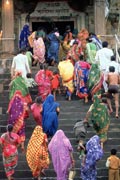 Indian women and children climbing the steps to a temple