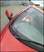 Girl driving red car