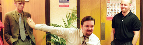 A manager does a silly dance in an office