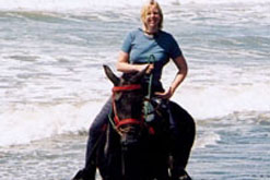 Wendy riding on a beach in Costa Rica