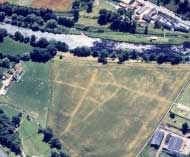 Aerial shot of lines in a field showing the streets of a Roman town