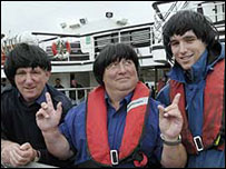 uncionários do ferry boat no rio Mersey com perucas dos Beatles