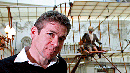 Presenter Saul David in front of a replica Bristol Boxkite on display in the Bristol City Museum and Art Gallery
