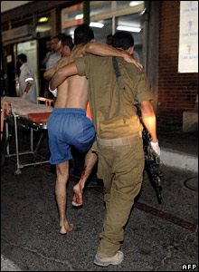 Wounded soldier is helped into hospital