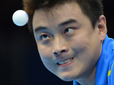 Wang Hao of China watches the ball during a table tennis match.