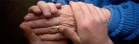 A carer holding an older person's hand