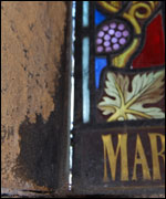 The window is detached from the stonework in places