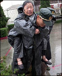 Mulher é carregada durante tempestade em Taizou