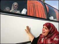 Tahliye edilenleri uğurlayan bir kadın